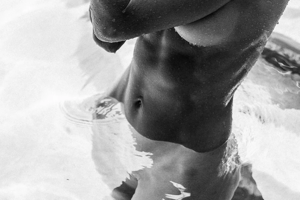 Black and white photograph of a figure in rippling water — CRZYPNDA photography